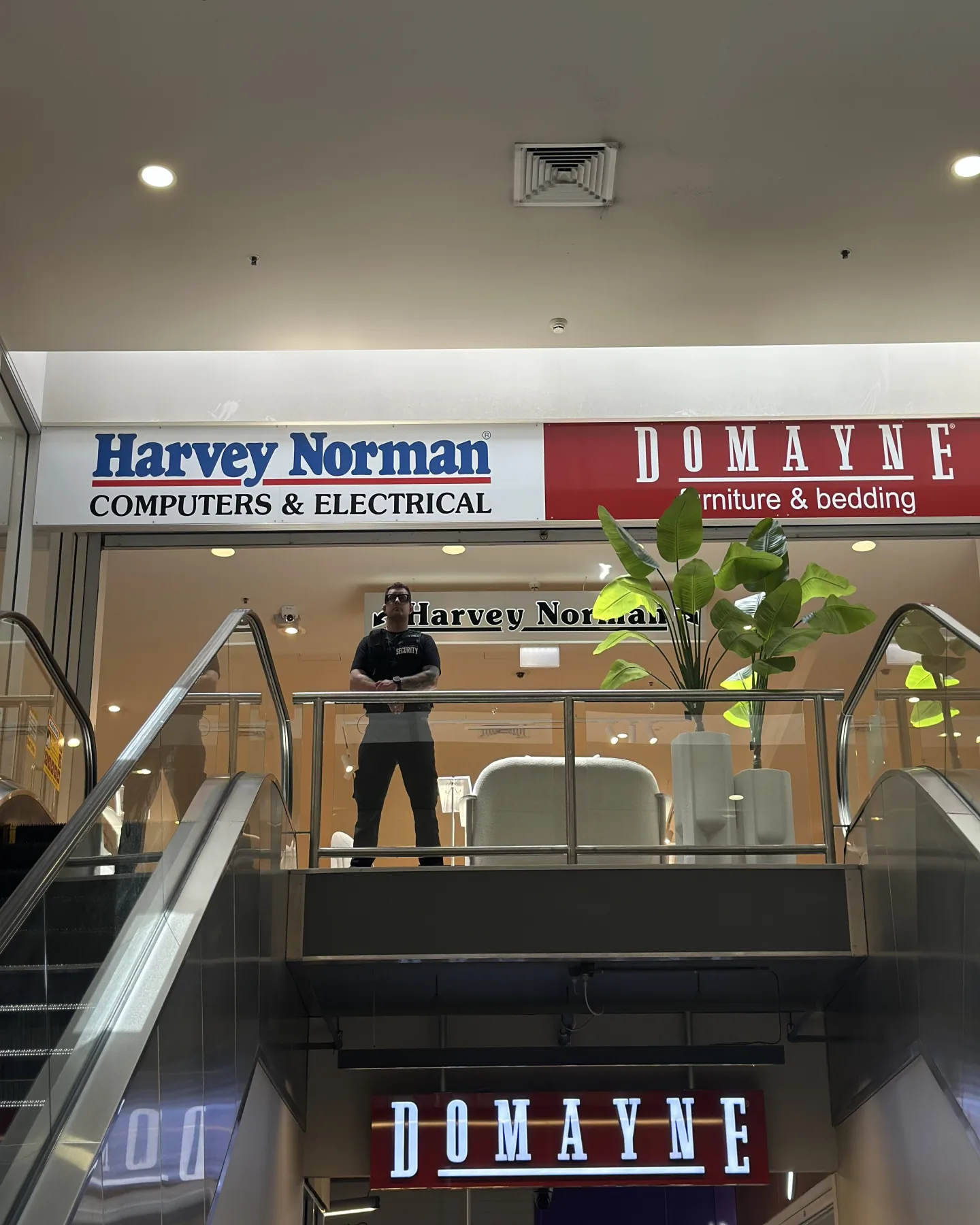 Elite Squad officer on the mezzanine of a homemaker centre above the escalators