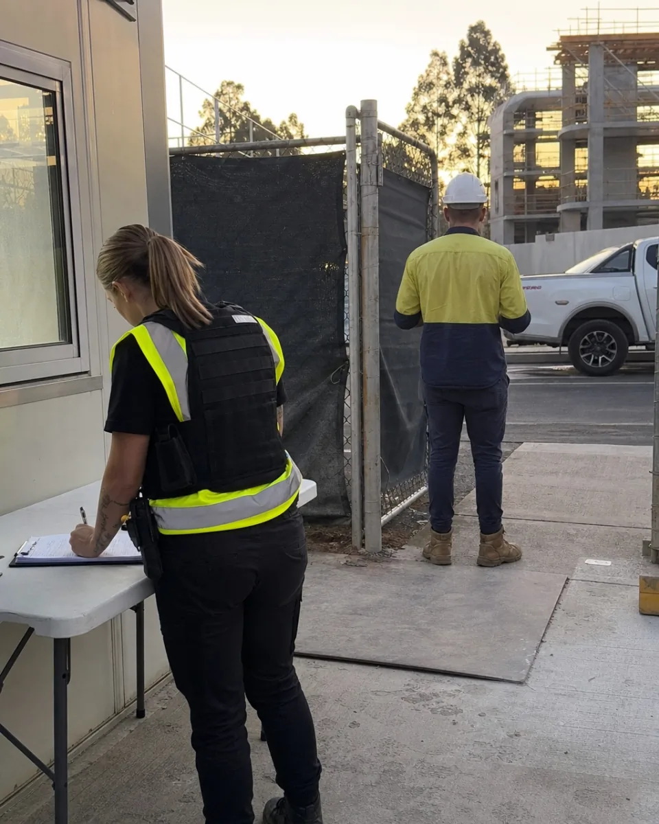 Security officer signing a tradesperson in at a Brisbane construction site gatehouse