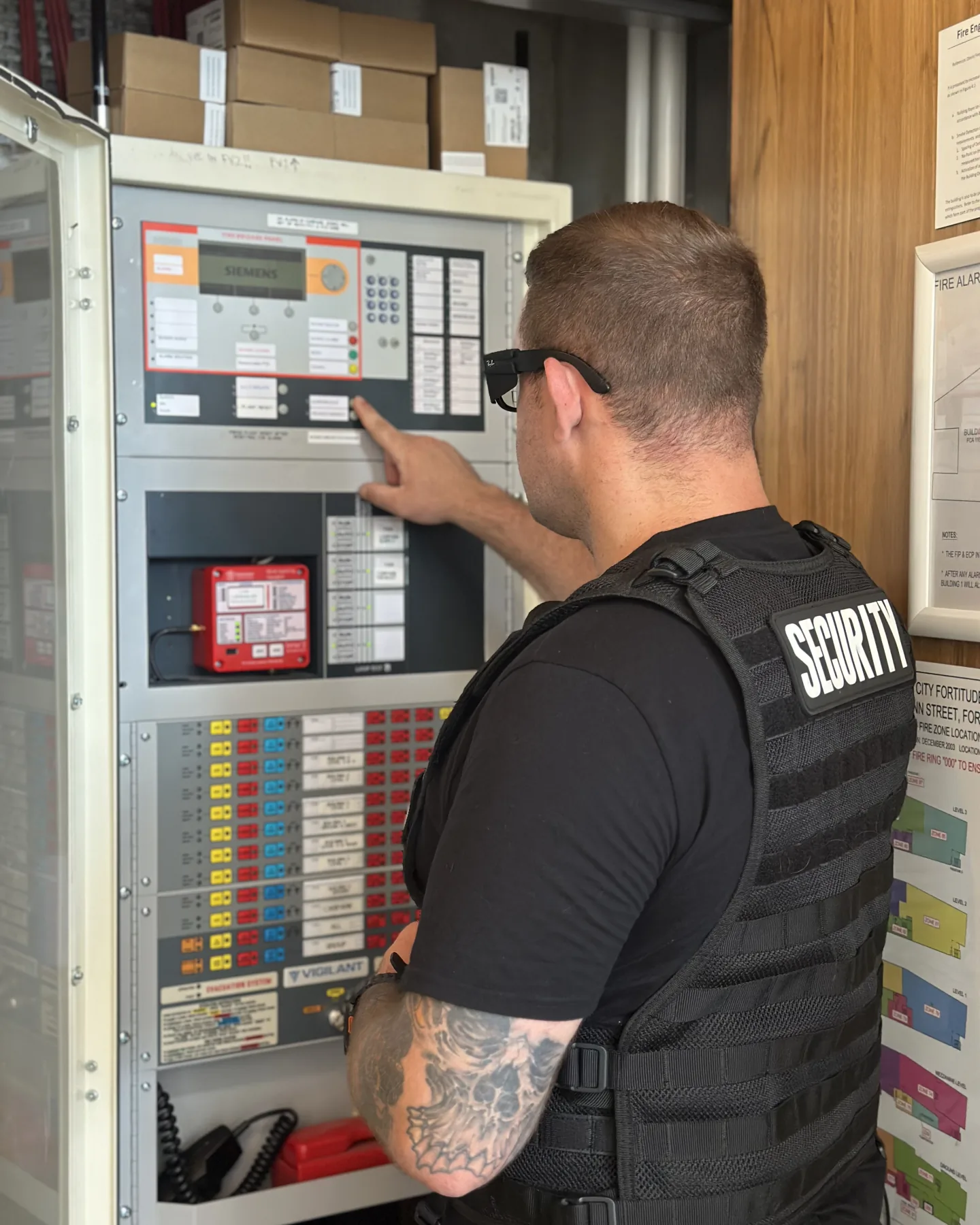 Elite Squad officer checking the alarm and services panel at a Brisbane retail centre