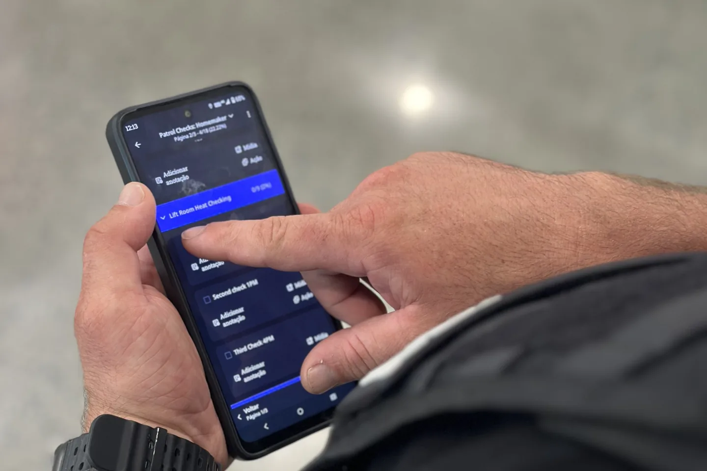 Officer logging a patrol check in the Boomerang app on a phone